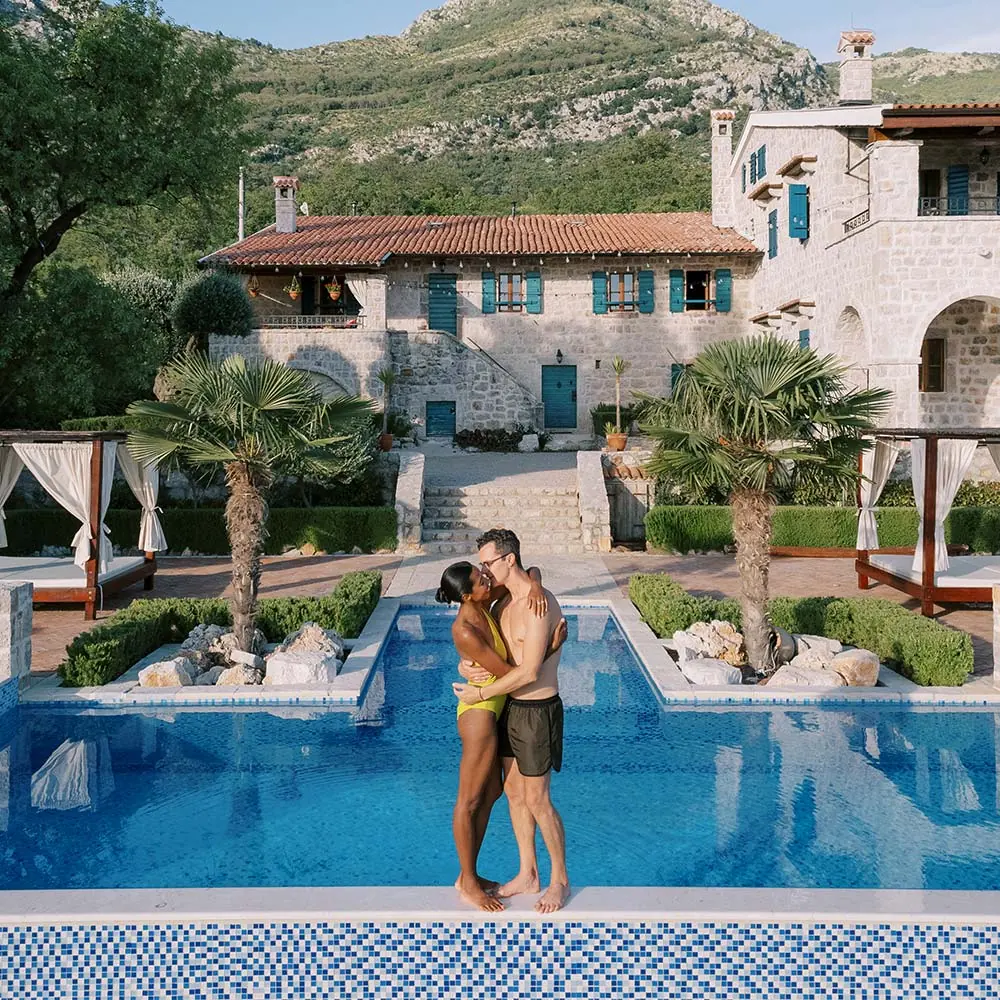 man-and-woman-kiss-while-hugging-on-the-edge-QQ8HQVY.webp