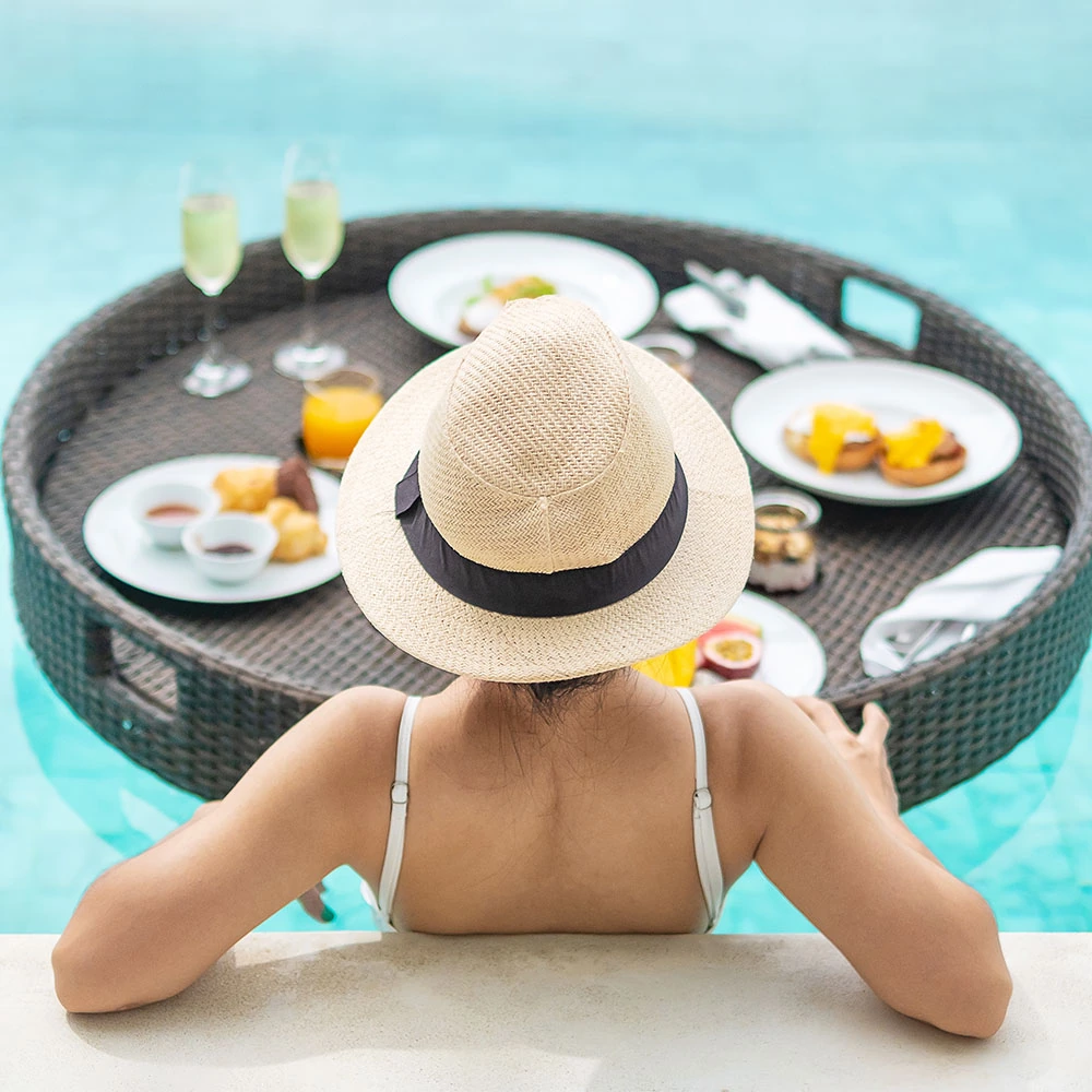 woman-with-floating-breakfast-in-pool-AKPVZX3.webp